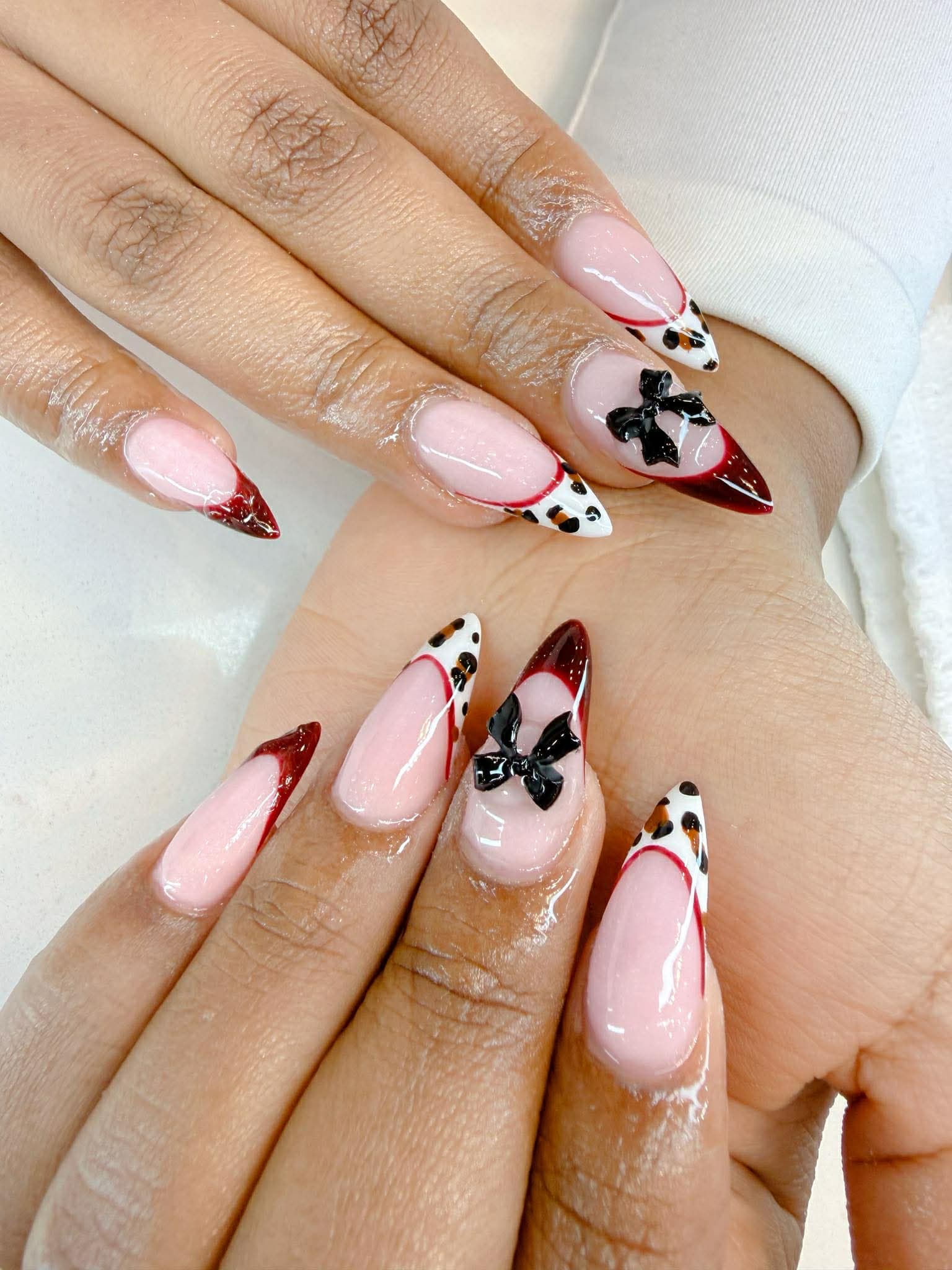 Leopard print French tips with bow accents