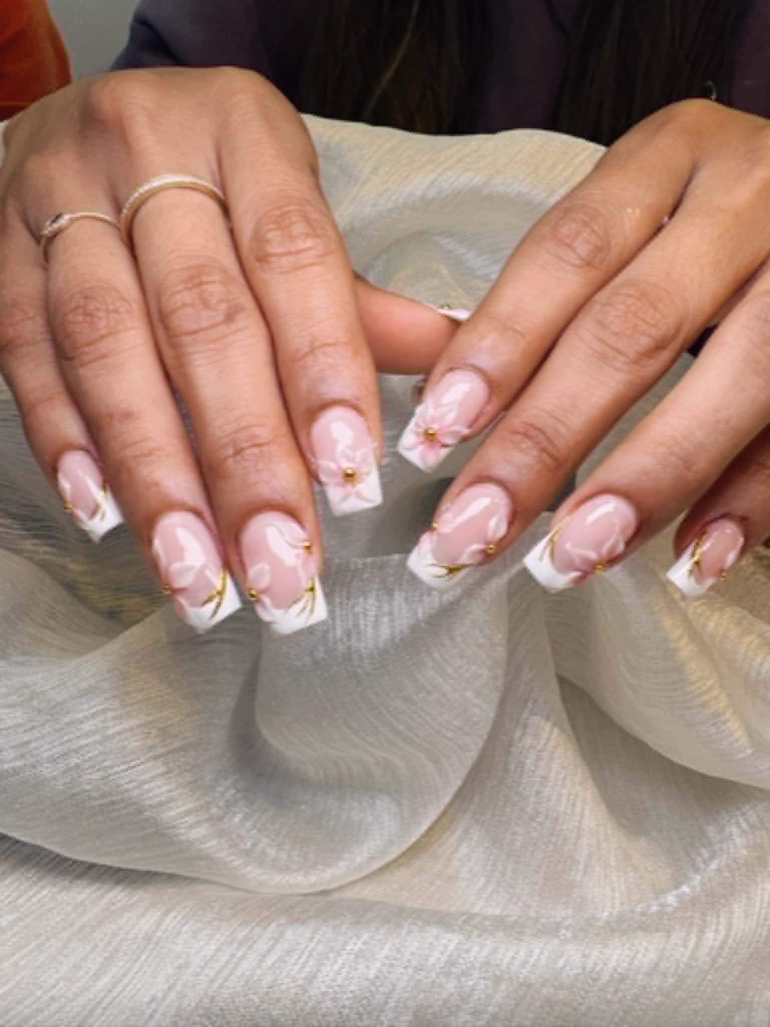 Elegant pink and white French tips with 3D floral accents